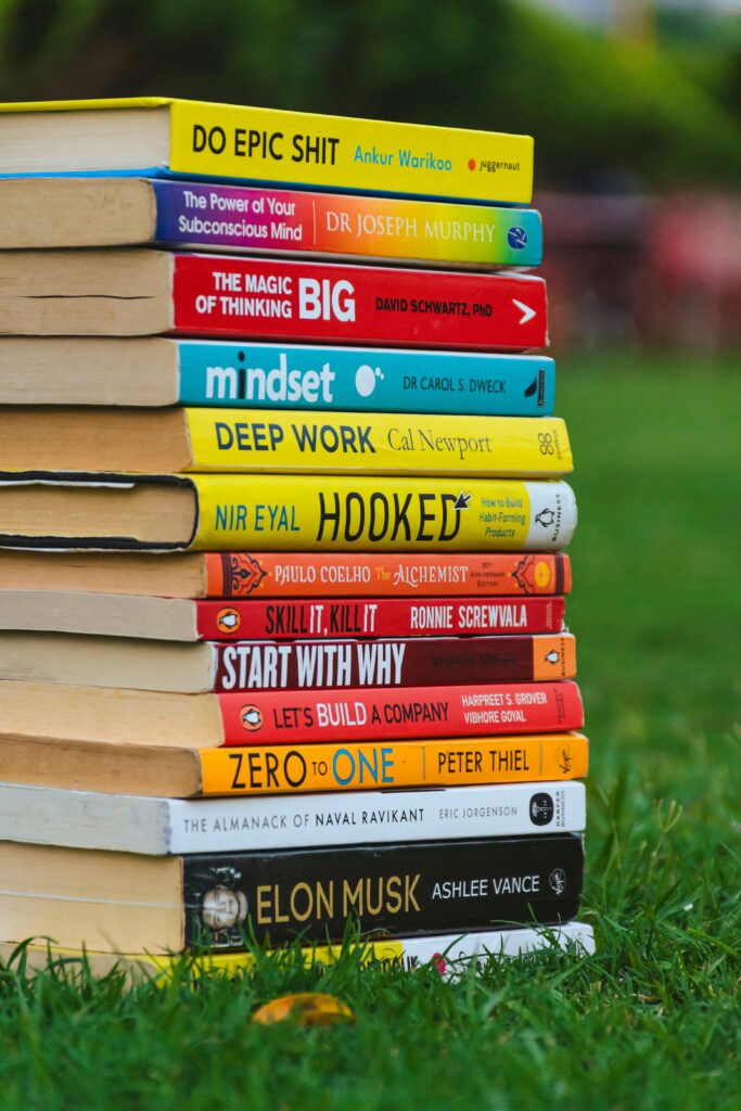 Stack of books representing the best FIRE books for building financial independence
